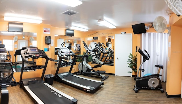 exercise room with hardwood / wood-style floors