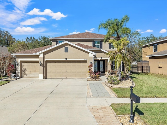 view of front of property with a garage and a front lawn