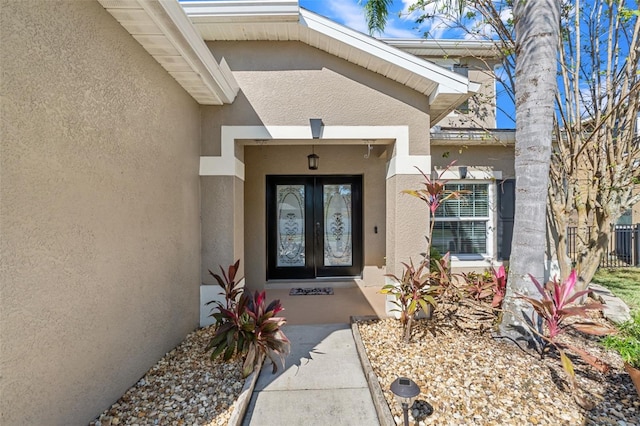 view of exterior entry featuring french doors