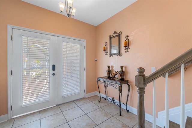 interior space with light tile patterned floors, french doors, and a notable chandelier