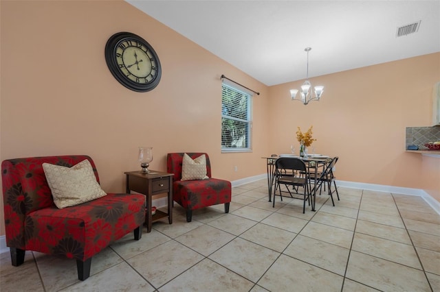 tiled dining area with a notable chandelier and vaulted ceiling