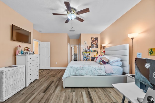 bedroom with ceiling fan and hardwood / wood-style floors