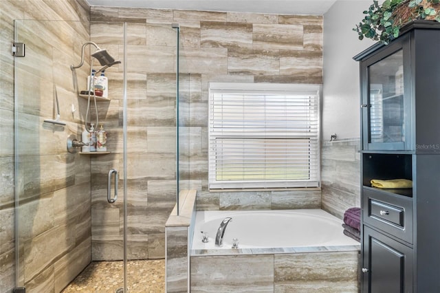 bathroom featuring separate shower and tub