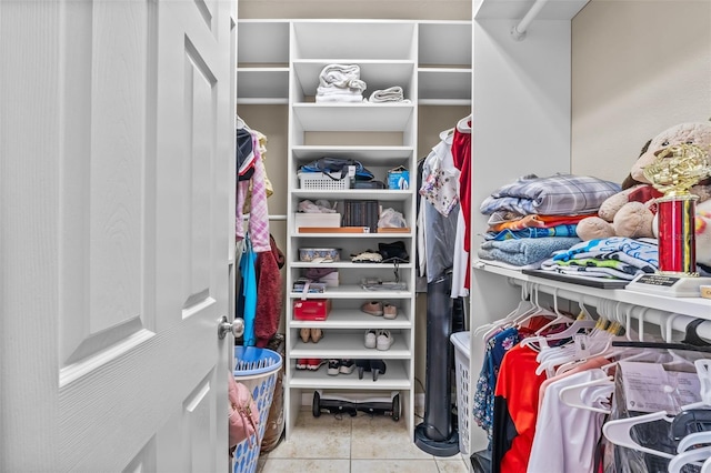 walk in closet with light tile patterned flooring