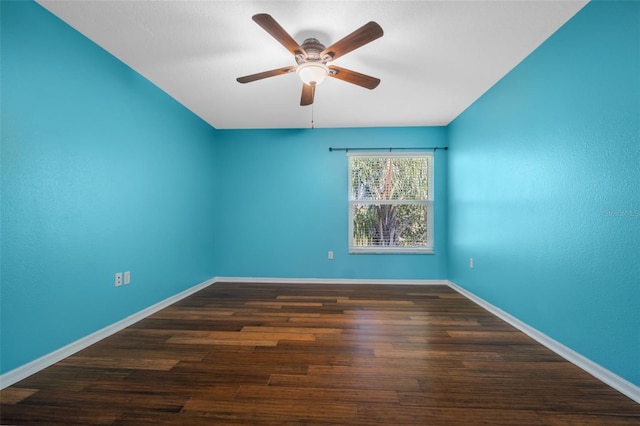 spare room featuring dark hardwood / wood-style flooring, vaulted ceiling, and ceiling fan