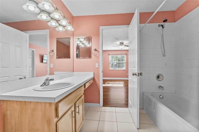 bathroom with tiled shower / bath, ceiling fan, vanity, and hardwood / wood-style flooring