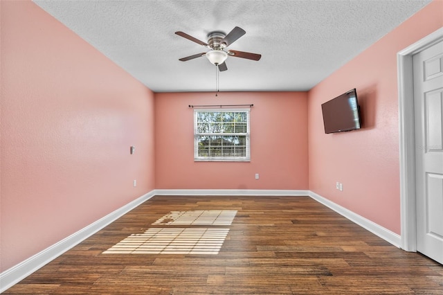 empty room with a textured ceiling, dark hardwood / wood-style floors, and ceiling fan