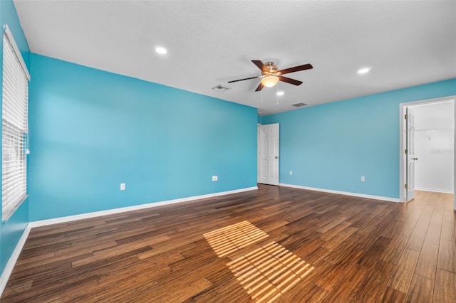 empty room featuring ceiling fan and dark hardwood / wood-style floors