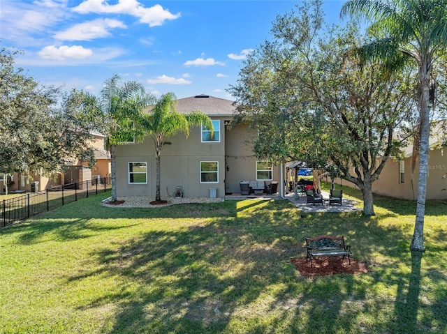 rear view of house featuring a lawn, outdoor lounge area, and a patio