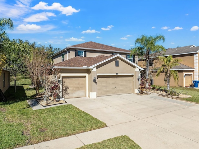 view of property featuring a garage and a front lawn