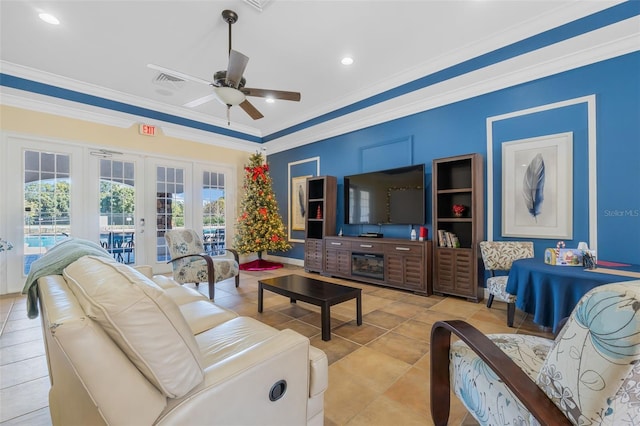 living room featuring ceiling fan, light tile patterned floors, crown molding, and french doors