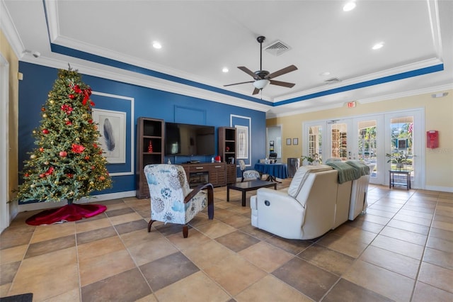 tiled living room featuring a raised ceiling and ornamental molding