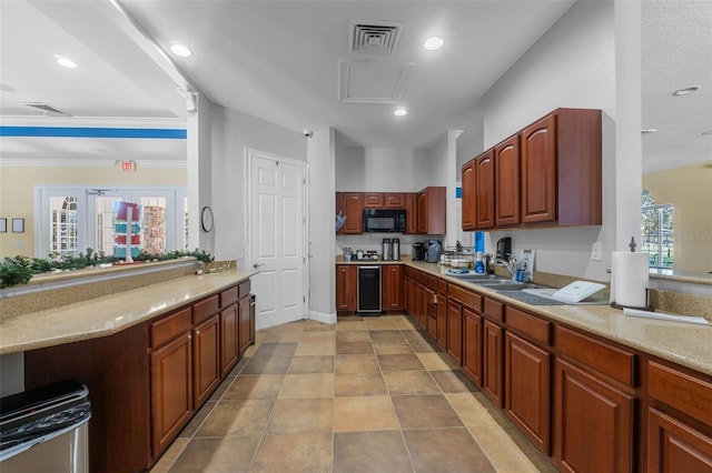 kitchen featuring light stone counters, wine cooler, plenty of natural light, and sink