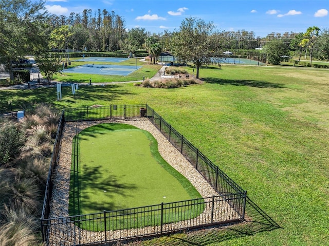 surrounding community featuring a yard, a water view, and basketball hoop