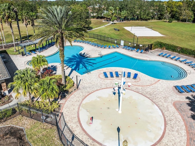 view of swimming pool with a yard