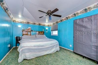 unfurnished bedroom with ceiling fan, carpet floors, and lofted ceiling