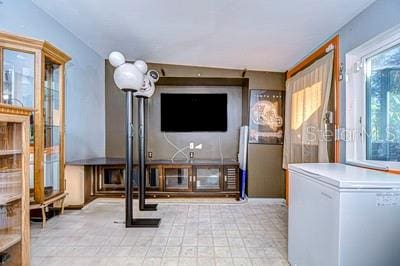 unfurnished living room featuring vaulted ceiling