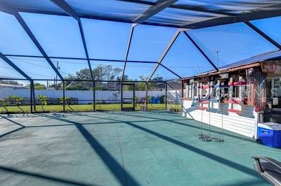 view of swimming pool featuring glass enclosure