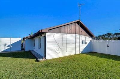 view of side of home featuring a lawn