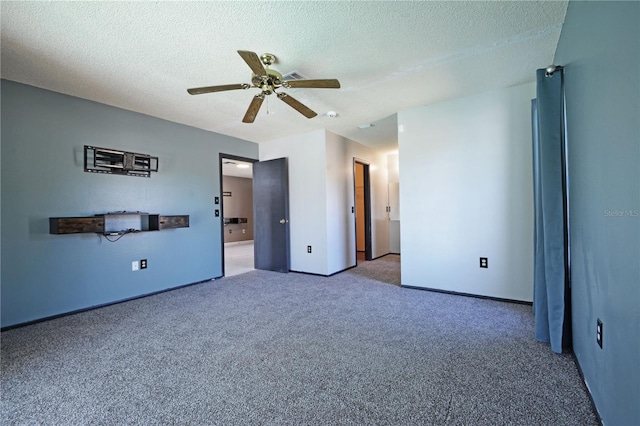 interior space with ceiling fan, carpet floors, and a textured ceiling