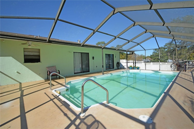 view of swimming pool with glass enclosure and a patio area