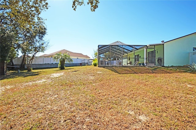 view of yard with glass enclosure