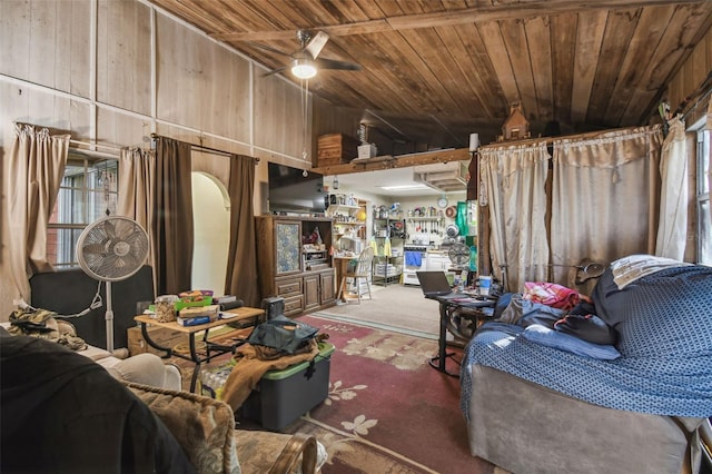 misc room with carpet, wood walls, wooden ceiling, vaulted ceiling, and ceiling fan