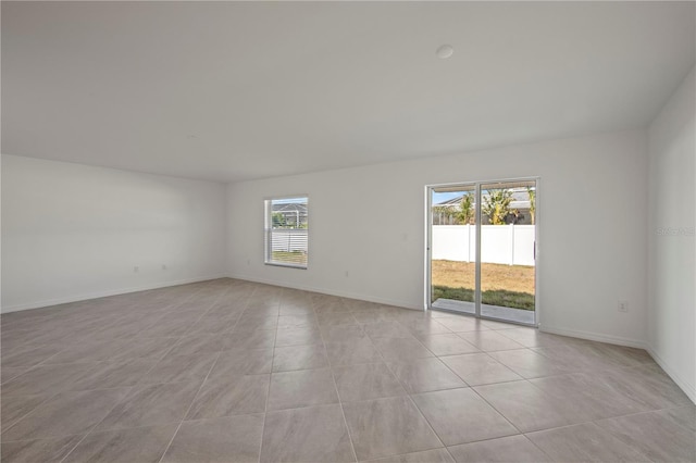 spare room featuring light tile patterned floors