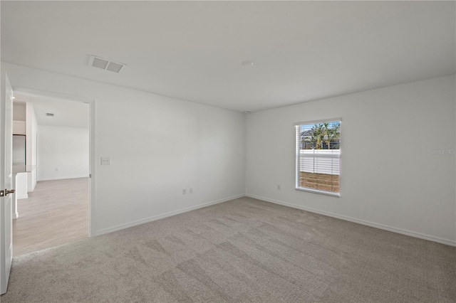 empty room featuring light colored carpet