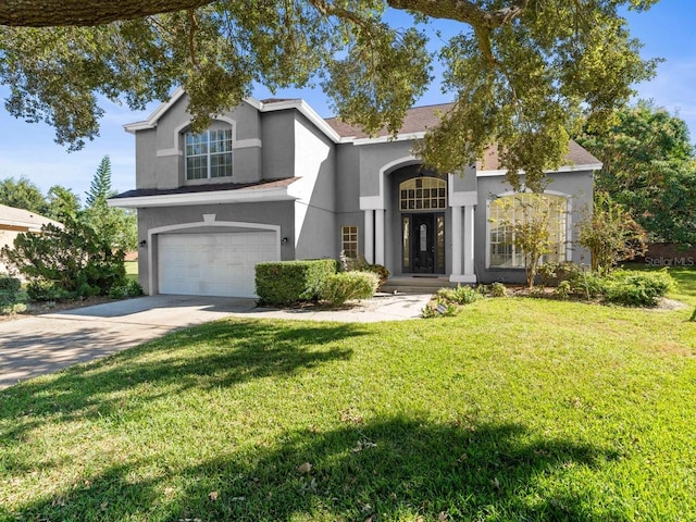 view of front facade with a front lawn and a garage