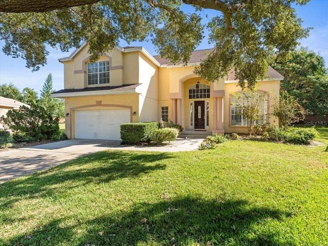 mediterranean / spanish home with a front lawn and a garage