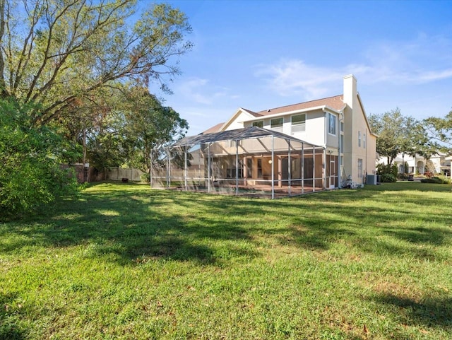 back of property with cooling unit, a lanai, and a yard