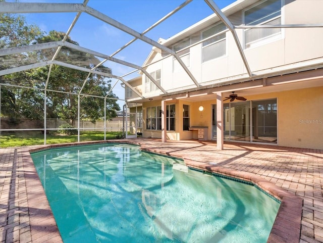 view of pool featuring a patio, ceiling fan, and a lanai