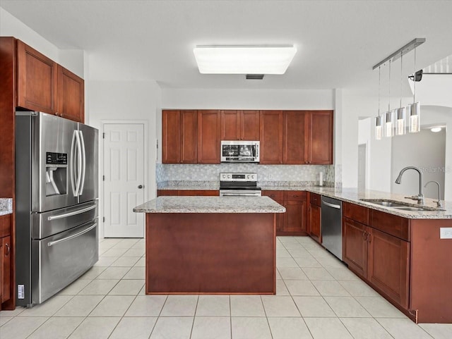 kitchen featuring pendant lighting, sink, decorative backsplash, appliances with stainless steel finishes, and light tile patterned flooring