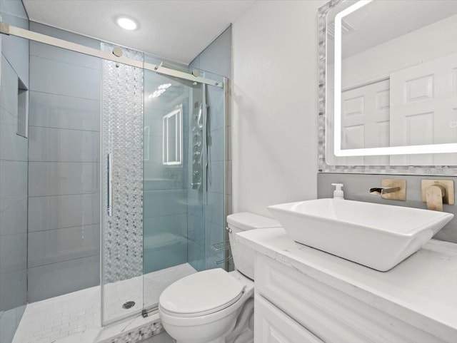 bathroom with vanity, toilet, and walk in shower