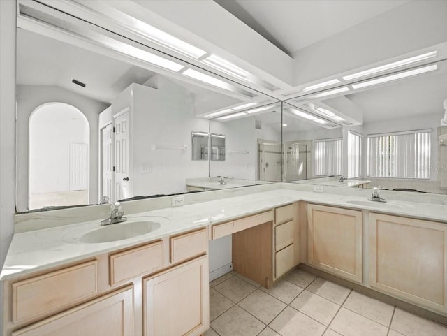 bathroom featuring lofted ceiling, tile patterned flooring, vanity, and an enclosed shower