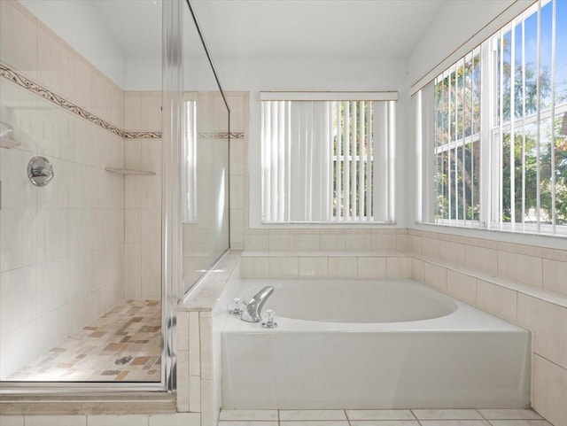 bathroom featuring tile patterned flooring and independent shower and bath