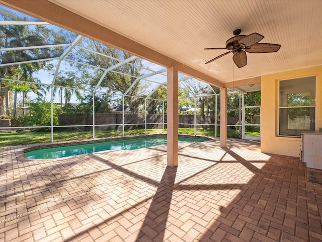 view of pool with ceiling fan, a patio, and glass enclosure