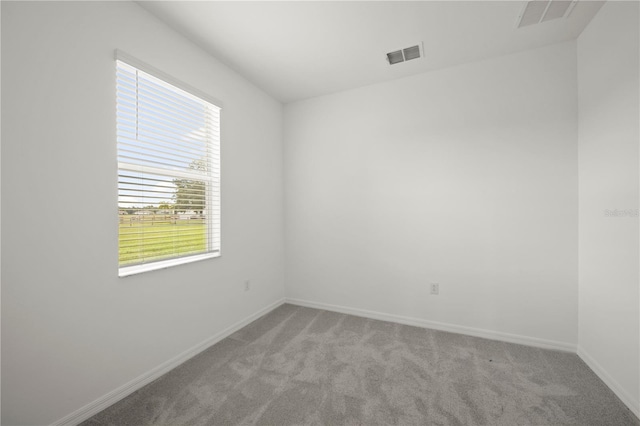 unfurnished room featuring light colored carpet