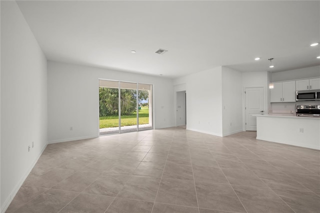 unfurnished living room featuring light tile patterned flooring