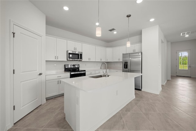 kitchen with white cabinetry, a kitchen island with sink, sink, and stainless steel appliances