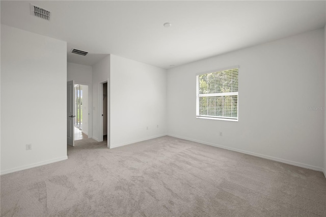 unfurnished room with light carpet