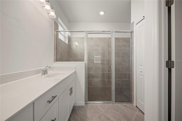 bathroom featuring tile patterned floors, vanity, and an enclosed shower