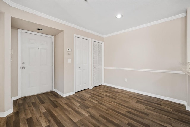 unfurnished bedroom featuring dark hardwood / wood-style flooring, two closets, and ornamental molding