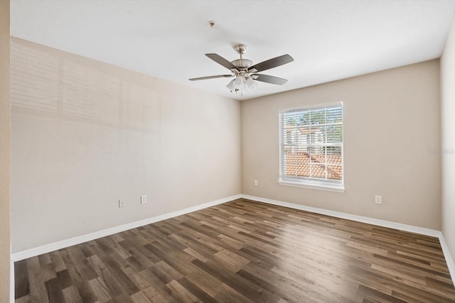 empty room with ceiling fan and dark hardwood / wood-style flooring