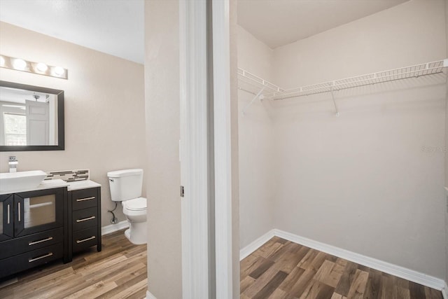 bathroom with vanity, hardwood / wood-style flooring, and toilet