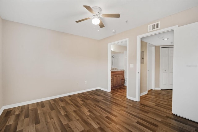 18106 Peregrines Perch Pl Unit 5204, Lutz, FL 33558 - unfurnished bedroom featuring dark wood-type flooring, baseboards, a ceiling fan, ensuite bath, and electric panel