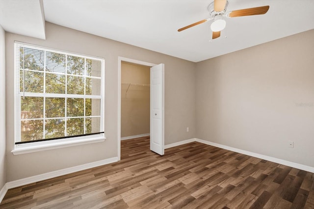 unfurnished bedroom featuring a closet, ceiling fan, and hardwood / wood-style floors