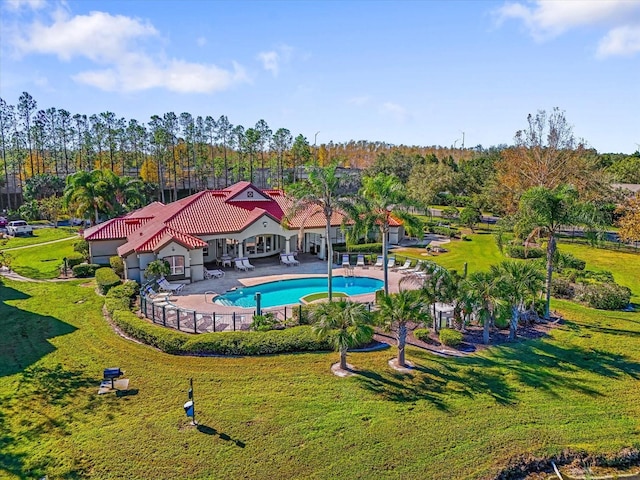 view of swimming pool featuring a yard and a patio area