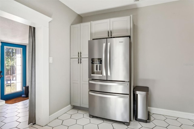 kitchen featuring stainless steel refrigerator with ice dispenser and white cabinets